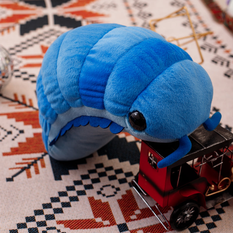 Giant deep sea isopod plushie held in lifestyle setting